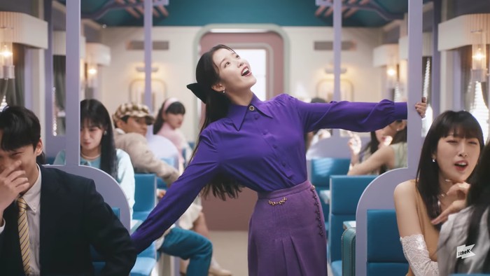 Saat scene memasuki kereta, IU tampil riang gembira dengan tarian menggemaskan. Outfit serba ungu yang dikenakannya tampak relevan dengan judul MV. Nuansa keceriaan seorang IU sangat tampak di sini. (Foto:youtube.com/1theK)