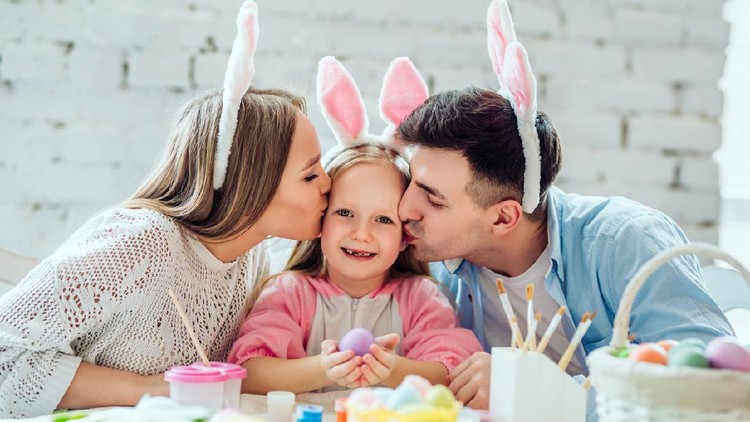 Ilustrasi Hari Paskah Lovely family paint easter eggs together.Happy little girl holding easter egg in hands.