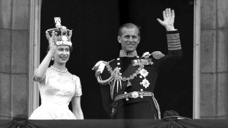 Britain Prince Philip FILE - In this June 2, 1953 file photo, Britain's Queen Elizabeth II and her husband, the Duke of Edinburgh, wave from the balcony of Buckingham Palace, London, following the Queen's coronation at Westminster Abbey. Buckingham Palace says Prince Philip, husband of Queen Elizabeth II, has died aged 99. (AP Photo/Leslie Priest, File)