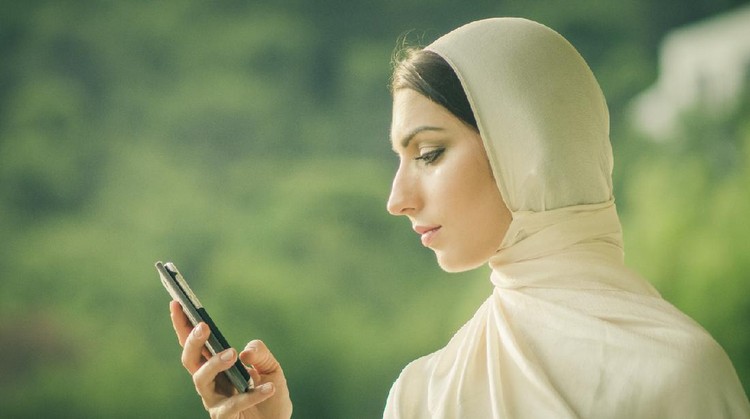 Ilustrasi Berkirim Pesan Ramadhan Closeup portrait of young attractive muslim female in hijab typing phone