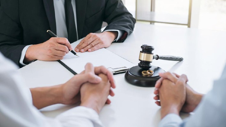 Agreement prepared by lawyer signing decree of divorce (dissolution or cancellation) of marriage, husband and wife during divorce process with male lawyer or counselor and signing of divorce contract.