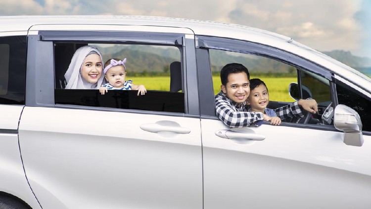 Portrait of Muslim family looking out of a car window while driving for travel on vacation