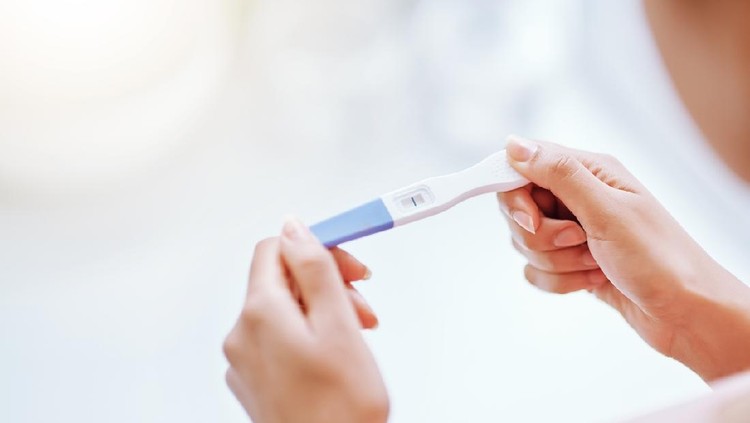 Cropped shot of a young woman taking a pregnancy test
