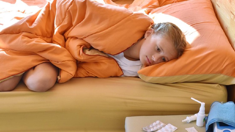 Kid and pills. Abdominal pain in a child. The girl is suffering from pain.