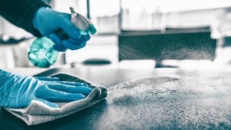 Ilustrasi membersihkan dapur Cleaning home table sanitizing kitchen table surface with disinfectant spray bottle washing surfaces with towel and gloves. COVID-19 prevention sanitizing inside.