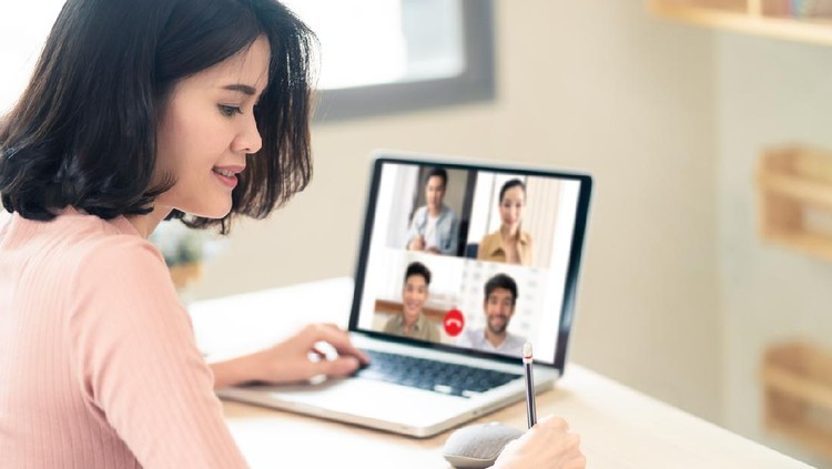 Asian business woman talking to colleague team about plan in video conference. Group of multiethnic business people using computer for online meeting in video call conference. Smart working from home.