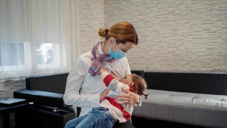 Motherhood Exhaustion Concept. Tired young mom breastfeeding baby and working on laptop at home, feeling frustrated, free space