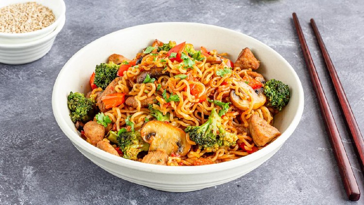 Ramen Noodles with Broccoli, Bell Pepper, Mushroom, and Chicken in a Bowl with Chopsticks.