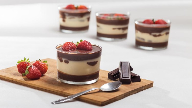 Mascarcope dessert with layered chocolate, decorated with strawberries, served in a crystal glass