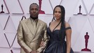 Leslie Odom Jr&period;&comma; left&comma; and Nicolette Robinson arrive at the Oscars on Sunday&comma; April 25&comma; 2021&comma; at Union Station in Los Angeles&period; &lpar;AP Photo&sol;Chris Pizzello&comma; Pool&rpar;