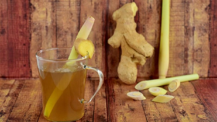Hot ginger lemongrass tea on wooden background
