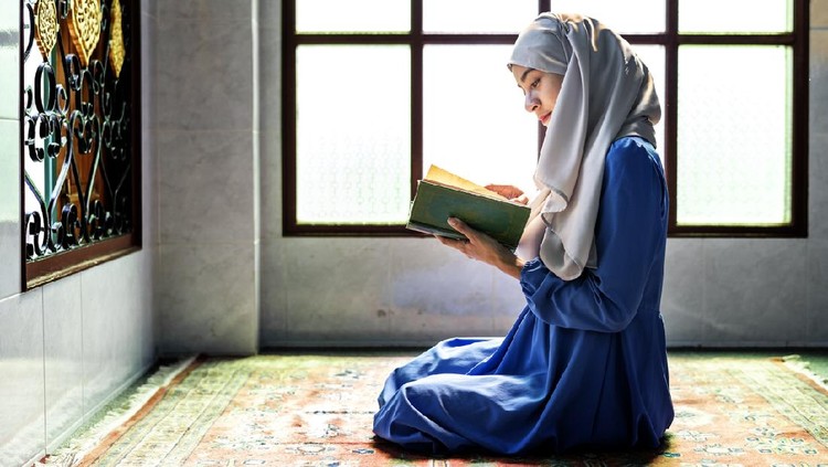 Muslim woman reading from the quran
