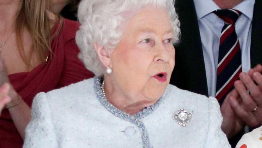 LONDON, ENGLAND - FEBRUARY 20:  Queen Elizabeth II reacts as she views Richard Quinn's runway show before presenting him with the inaugural Queen Elizabeth II Award for British Design as she visits London Fashion Week's BFC Show Space on February 20, 2018 in London, United Kingdom. (Photo by Yui Mok - Pool/Getty Images)