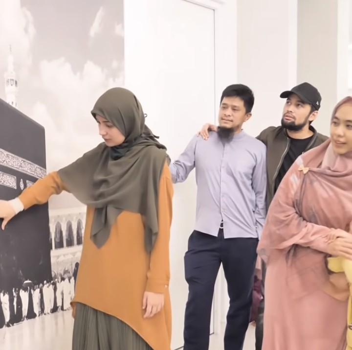 <p>Masih di lantai yang sama, salah satu sisi tembok di rumah pedakwah ini terdapat mural Kabah. Kata Oki, ini bisa mengingatkannya pada Tanah Suci sekaligus menjadi spot untuk menenangkan diri. (Foto: YouTube: The Sungkars Family)</p>