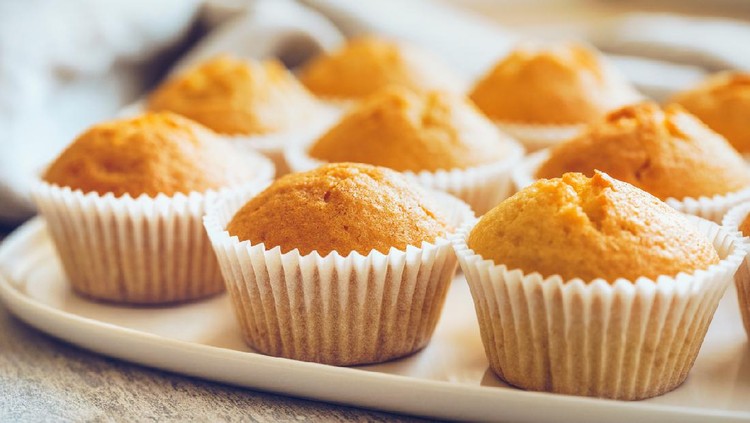 Unfrosted cupcakes on a white plate