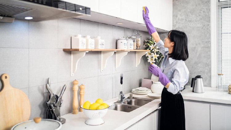 Asian woman cleaning the kitchen.