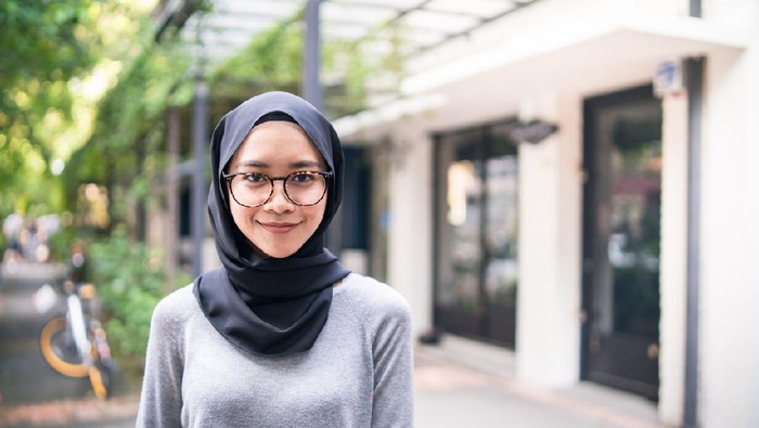 Indonesian or Malaysian woman with headscarf in the restaurant