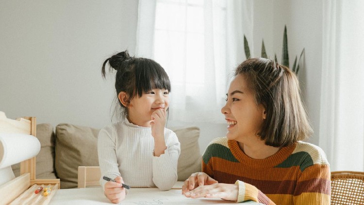 an asian chinese mother cooking preparing food at kitchen counter  with her daughter