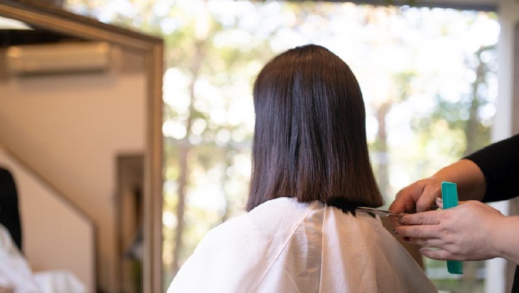 Woman cutting hair for charitable donation