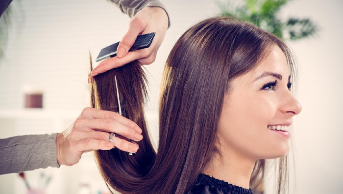Woman cutting hair for charitable donation