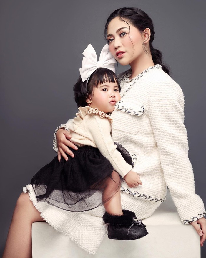 Rachel Venya mengajak Chava duduk di pangkuannya untuk membuat sang putri nyaman saat berfoto bersama/Sumber/Instagram/rachelvennya.