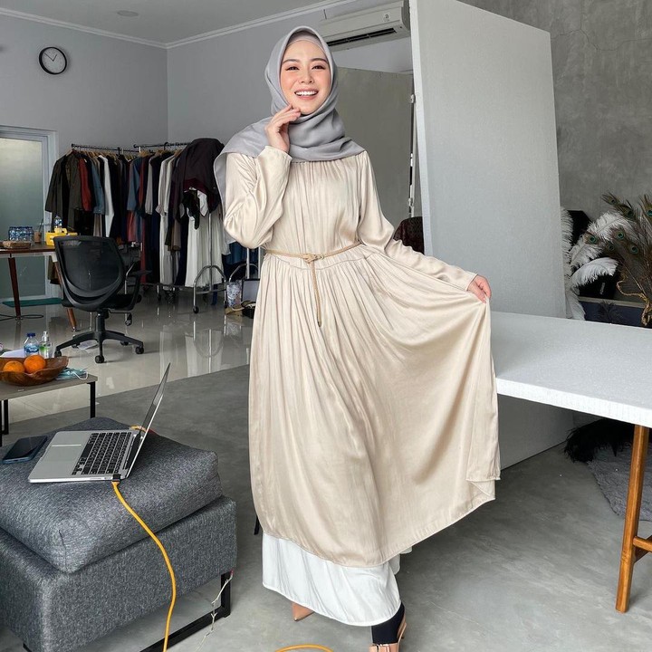 <p>Tampilan <em>simple</em> dan <em>effortless</em> juga bisa didapatkan dari gamis polos. Seperti Ayana, Bunda bisa padukan midi dress warna beige dengan inner rok warna putih. (Foto: Instagram: @xolovelyayana)</p>