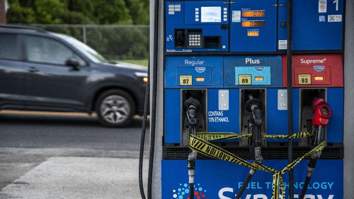 Caution tape is wrapped around fuel pumps at an Exxon Gas Station on Boonsboro Road in Lynchburg, Va., Tuesday, May 11, 2021. More than 1,000 gas stations in the Southeast reported running out of fuel, primarily because of what analysts say is unwarranted panic-buying among drivers, as the shutdown of a major pipeline by hackers entered its fifth day. In response, Virginia Gov. Ralph Northam declared a state of emergency. (Kendall Warner/The News & Advance via AP)