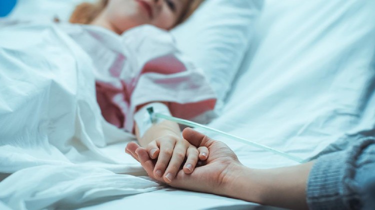 Recovering Little Child Lying in the Hospital Bed Sleeping, Her Hand Falls into Mother's and She Holds it Comfortingly. Focus on the Hands. Emotional Family Moment.