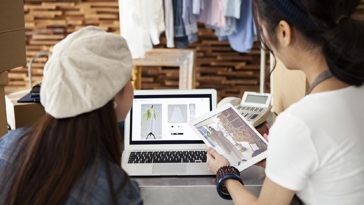 Two women selling clothes at online shopping
