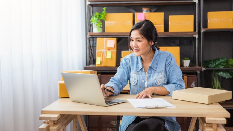 Young Asian female freelancer using her laptop and working at home, Small business female owner or Start up small business entrepreneur working online marketing packaging box delivery