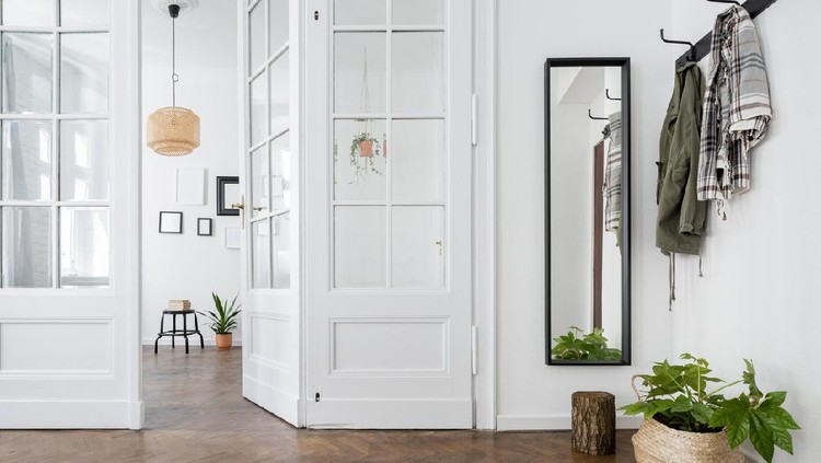 Spacious and stylish home interior with old glass door and wooden parquet