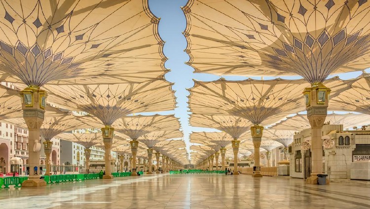 Courtyard of the Al Haram or Al-Masjid an-Nabawi mosque in Medina Saudi Arabia on a sunny day. It was the second mosque built by Muhammad in Medina and is now one of the largest mosques in the world.