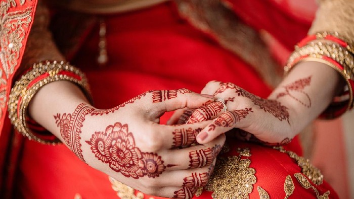 Cropped shot of an unrecognizable woman holding a ring in preparation for her wedding