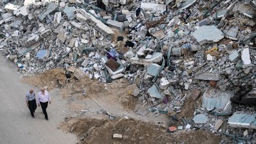 People walk by the rubble of the al-Jalaa building following a cease-fire reached after an 11-day war between Gaza's Hamas rulers and Israel, in Gaza City, Friday, May 21, 2021. The building housed The Associated Press bureau in Gaza City for 15 years. (AP Photo/John Minchillo)