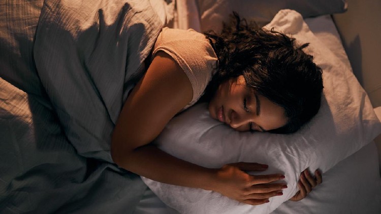 High angle shot of a beautiful young woman sleeping in her bed at home during the night