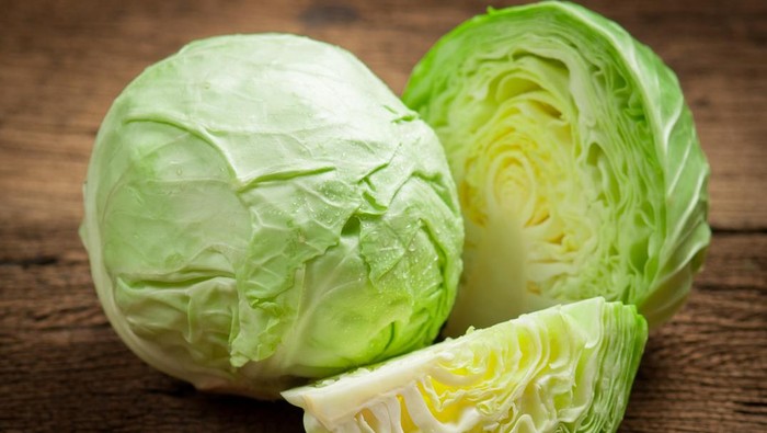 cabbage and cutted cabbage on wooden