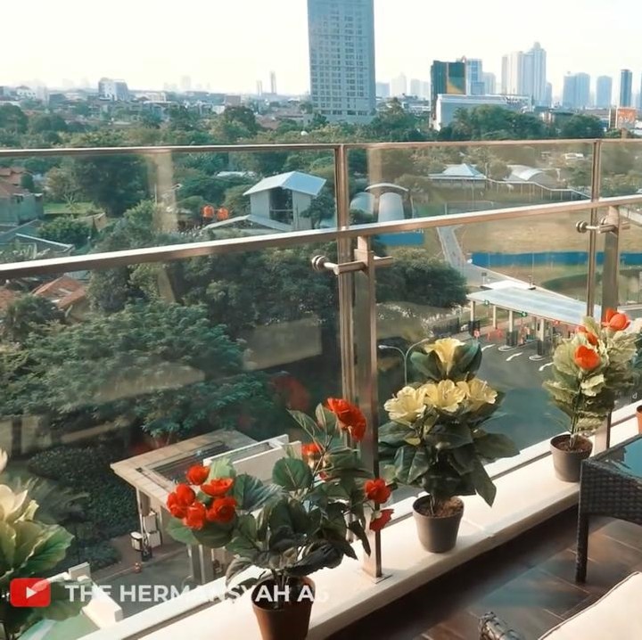 <p>Apartemen Ashanty memiliki dua balkon yang memperlihatkan pemandangan kota Jakarta. Pada balkon pertama, ruangan dipenuhi dengan tanaman hias bunga dan juga kursi santai. (Foto: YouTube The Hermansyah A6)</p>