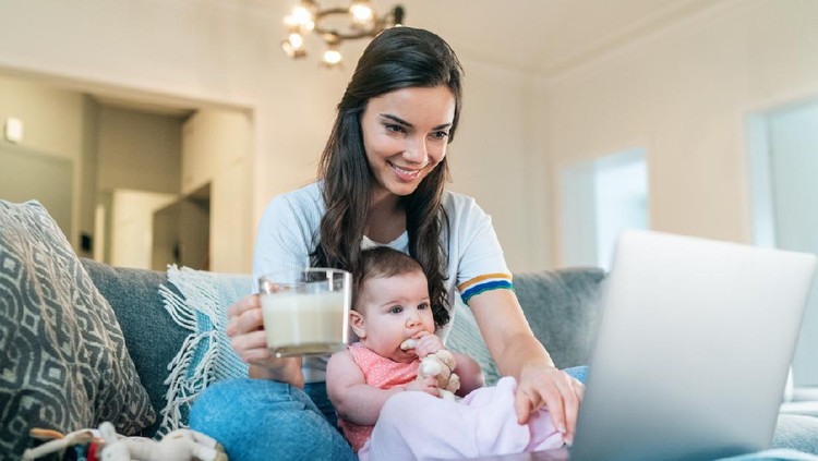 menyusui Young Mom Breastfeeding Baby While Working Remotely On Laptop At Home and eating