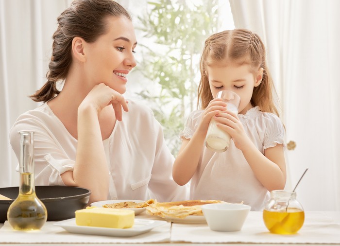 girl drinking milk at the kitchen