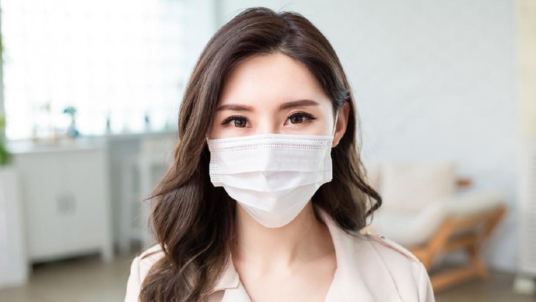 Asian Woman wears a facial mask and she look you