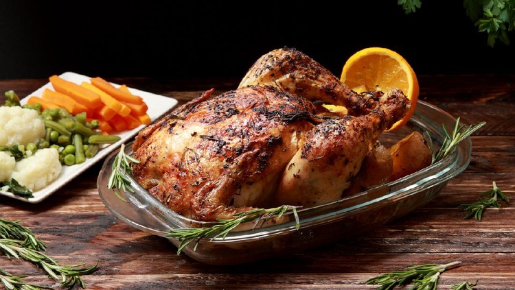 Traditional English Roast Chicken marinated with Herbs and Spices served with Roast Potatoes and Vegetables as a side dish