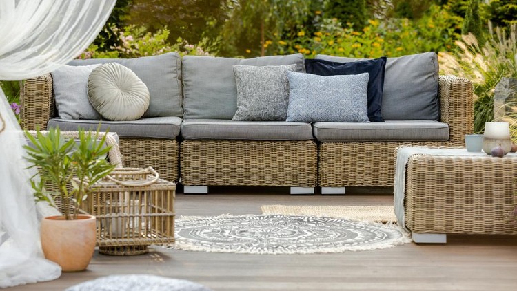 Modern wooden porch with rattan furniture outside the house