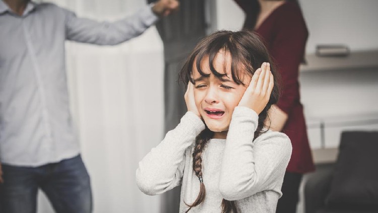 Little girl crying while parents quarrel. Closing the ears, 5-10 years old, vintage tone.