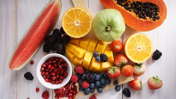 healthy fresh mixed fruits on white wooden table