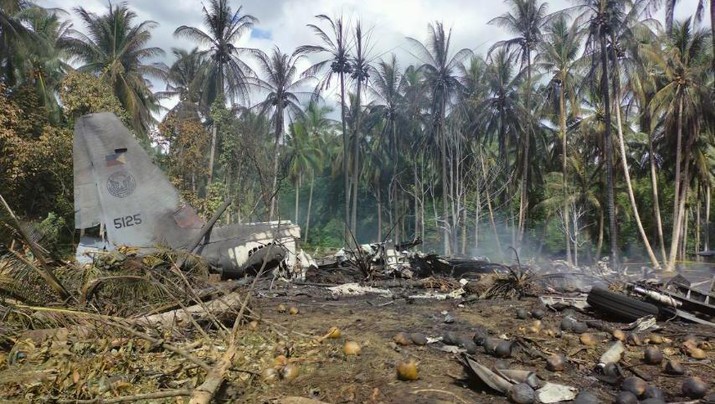 This photo released by the Joint Task Force - Sulu shows the remains of a Philippine military C-130 plane that crashed in Patikul town, Sulu province, southern Philippines on Sunday, July 4, 2021. The Philippine air force C-130 aircraft carrying troops crashed in a southern province after missing the runway Sunday, killing more than a dozen military personnel while at least 40 were rescued from the burning wreckage, officials said. (Joint Task Force-Sulu via AP)
