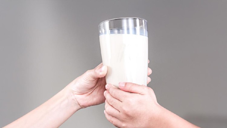 Mother and child holding a glass of milk