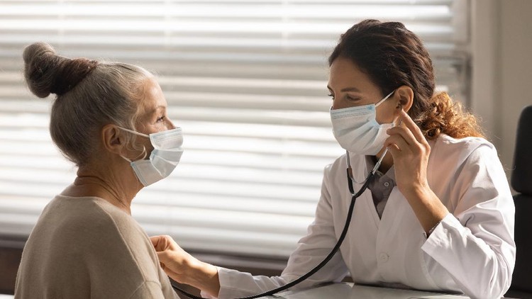 1163519043 Woman holding a mask nebulizer inhaling fumes spray the medication into your lungs sick patient. Self-treatment of the respiratory tract using inhalation nebulizer