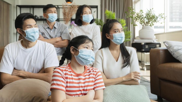 strong healthy asian family wearing surgical protective face mask stay quarantane together at home social distacing new normal lifestyle