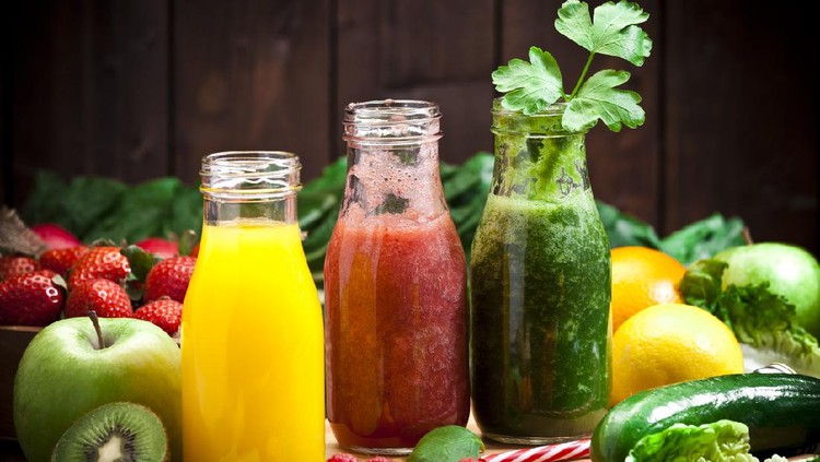 Healthy eating concept: Horizontal shot of three detox drinks in glass bottles with fruits and vegetables all around them on rustic wood table. DSRL studio photo taken with Canon EOS 5D Mk II and Canon EF 70-200mm f/2.8L IS II USM Telephoto Zoom Lens