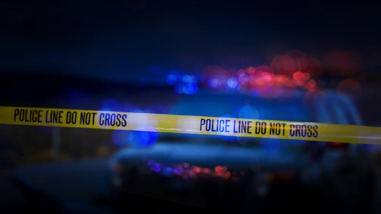 Yellow crime scene do not cross barrier tape in front of defocused background. Horizontal composition with selective focus and copy space.